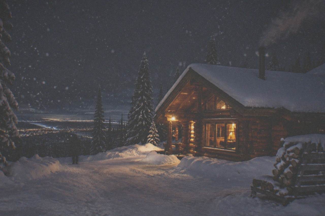 A warm wooden viewing lodge with large north-facing windows under a dark winter sky