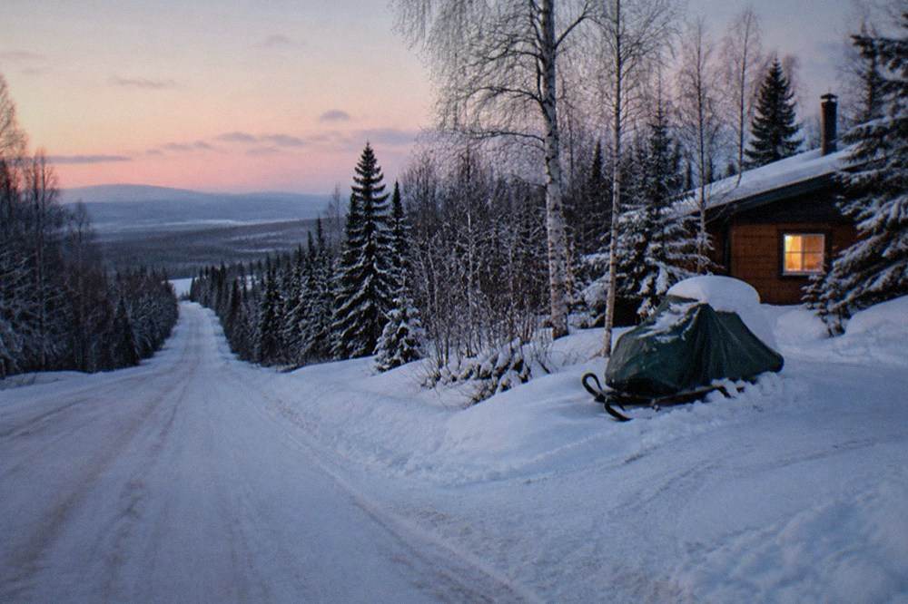 Quiet snowy road on the outskirts of Fairbanks in late afternoon twilight