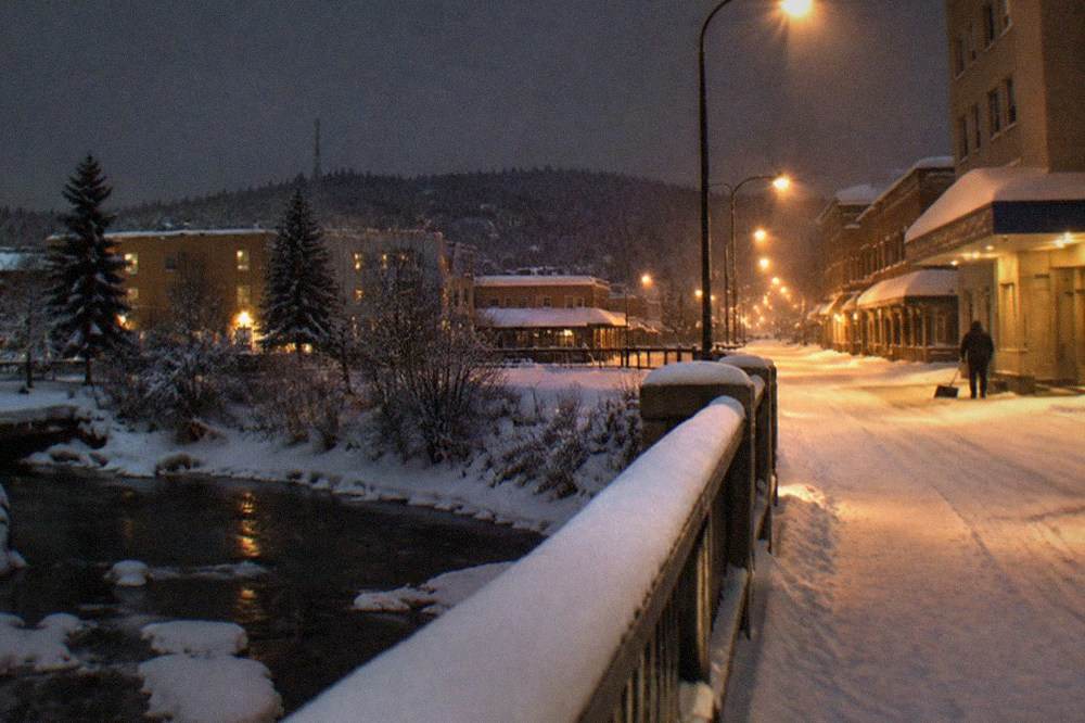 Fresh snow covering Fairbanks streets under a dark evening sky